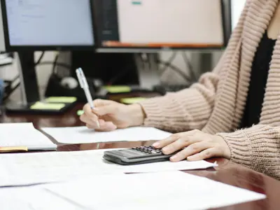 Someone using a calculator at a desk